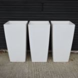 A set of three white garden pots,