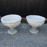 A pair of circular reconstituted stone planters,