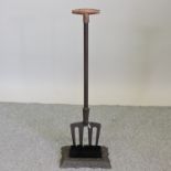 A long handled boot scraper, 90cm high,