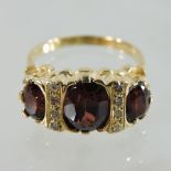 An 18 carat gold garnet and diamond set ring,