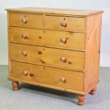 A Victorian pine chest of drawers, on turned feet,