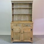 A light oak dresser, with thumbnail decoration,