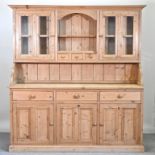 A modern pine dresser, with a glazed upper section,