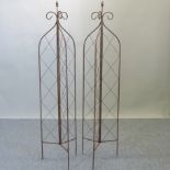 A pair of rusted metal garden spires,