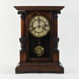 An early 20th century walnut mantel clock,