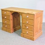 A modern pine pedestal desk,