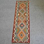 An Iranian woollen runner, with five central medallions,