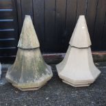 A pair of terracotta stone finials,