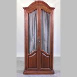 A French style walnut armoire, fitted with drawers and shelves,