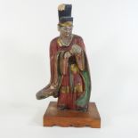 A painted wooden figure of a Chinese man,