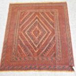 An Afghan rug, with a large central medallion, on a red ground,