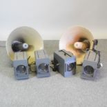 A collection of four spotlights, together with a pair of vintage enamel speakers,