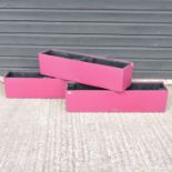 A set of three red garden troughs,