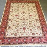 A Keshan style rug, with all over foliate design, on a cream ground,