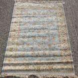 A Persian style rug, with floral designs on a blue ground,