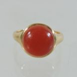 An 18 carat gold ring, set with a jasper cabochon,