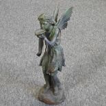 A cast iron model of a fairy, 52cm high, together with a similar figure,