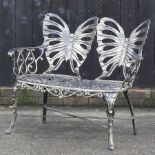 A metal garden bench with butterfly decoration,
