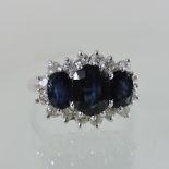 An 18 carat gold sapphire and diamond cluster ring,