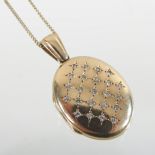 A 9 carat gold and diamond set locket, of hinged oval shape,