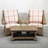 A pair of wicker armchairs, with cushions,