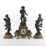 A 19th century French figural three piece clock garniture, with a drum movement, striking on a bell,