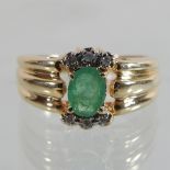 A 14 carat gold emerald and diamond ring,