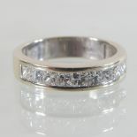 A 14 carat gold diamond half hoop eternity ring, the princess cut stones approx 1.