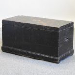 An early 20th century black painted pine trunk,