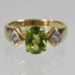 An 18 carat gold peridot and diamond ring,