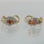 A pair of unmarked yellow sapphire and diamond earrings, boxed,