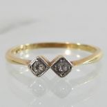 An 18 carat gold two stone diamond ring