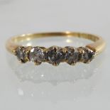 An 18 carat gold and platinum set five stone diamond ring