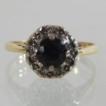 An 18 carat gold diamond and sapphire cluster ring