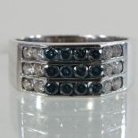 A 14 carat white gold diamond and blue diamond ring, approximately 0.