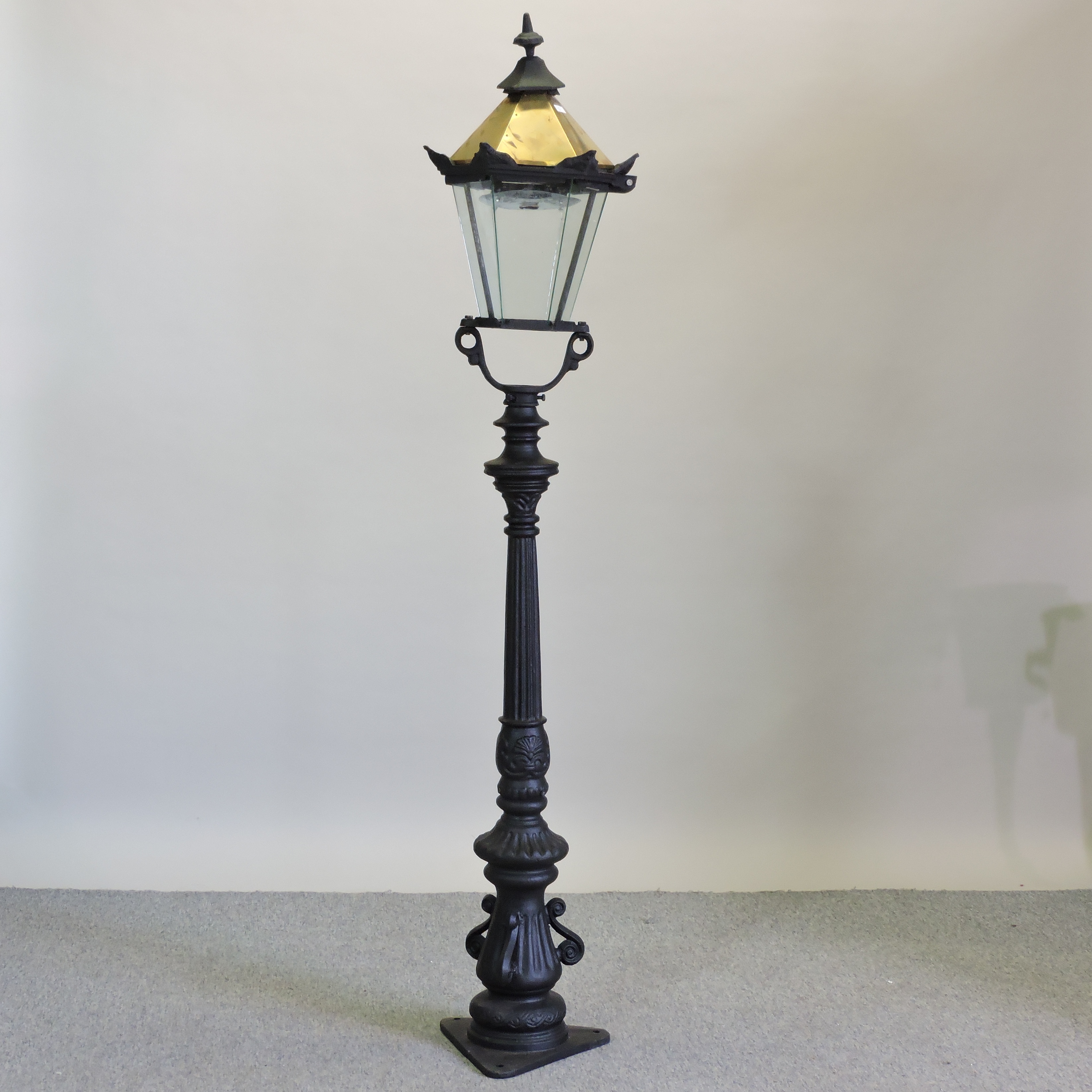 A Victorian style black painted metal lamp post,