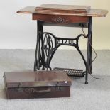 A Singer sewing machine on a cast iron stand, 91cm,