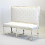 A French style cream upholstered high back sofa, on turned legs, united by shaped stretchers,