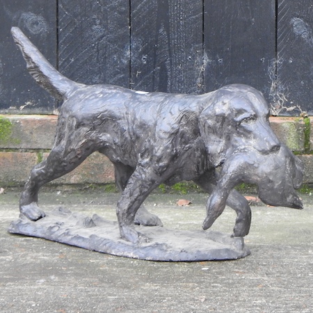 A cast metal figure of a gun dog,