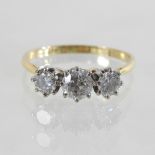 An 18 carat gold diamond three stone ring, approx 1.