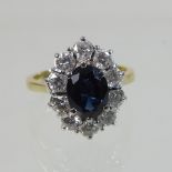 An 18 carat gold sapphire and diamond cluster ring,