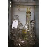 A four section glass decanter from the French Alps plus two cut glass bottles (3)