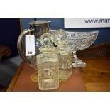 A crystal glass boat shaped centrepiece, together with a pair of decanters and a jug. (4)