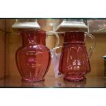 Two antique cranberry glass jugs.