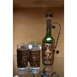 Copper sleeved bottle and six glasses.