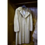 A three quarters length pastel mink coat.