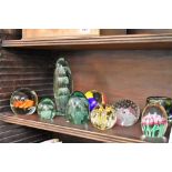 A collection of paperweights including four Victorian green glass dump weights.