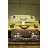 A set of three vintage suitcases to include a vellum case stamped with a Harley Street address (3)