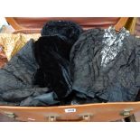 A collection of Victorian mourning clothes to include a fringed shawl, silk petticoat and lace skirt