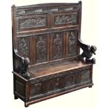 A 19th century carved oak settle, incorporating some earlier elements, the high, six panel back with